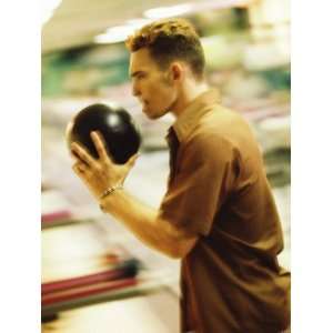  Side Profile of a Young Man Holding a Bowling Ball Premium 